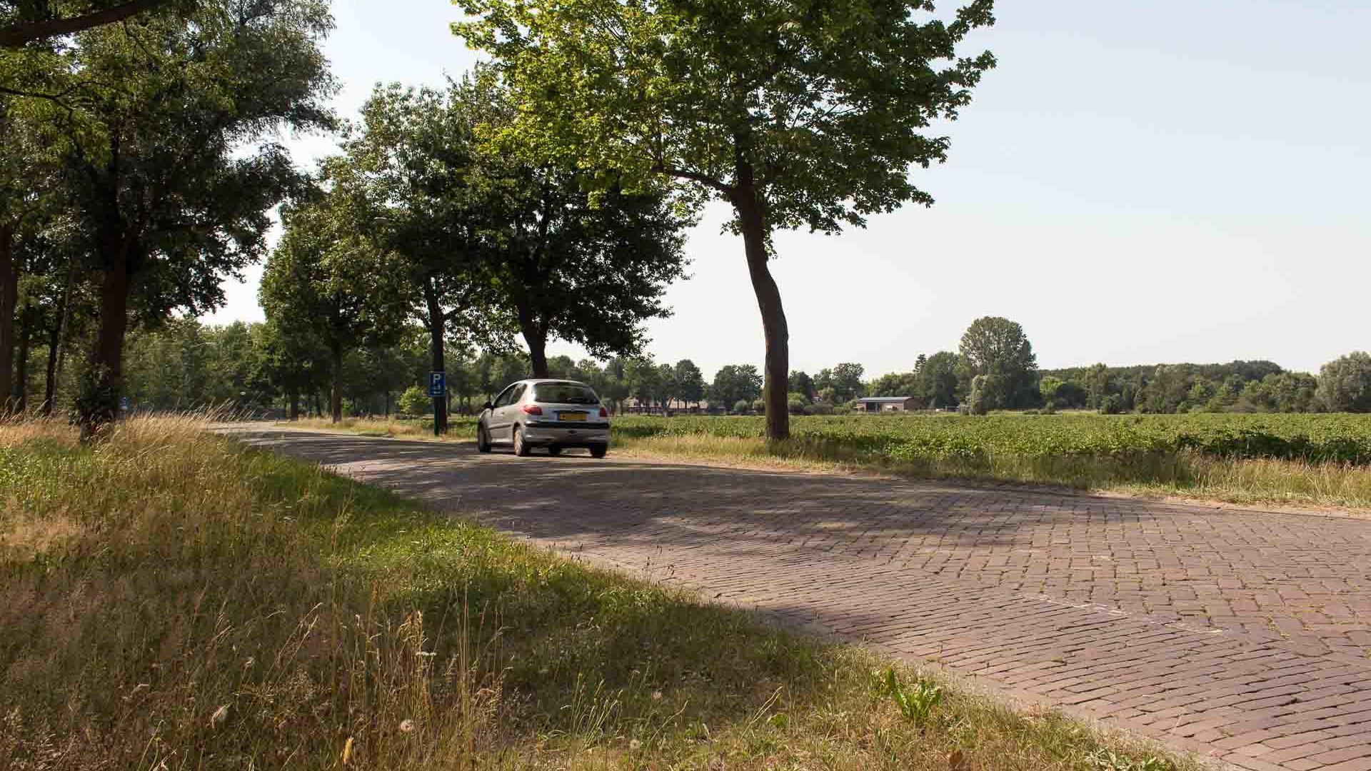 Een auto rijdend over de oude Broekdijk weg